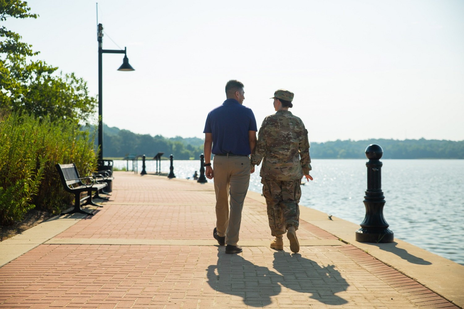 Active duty military couple walking along the water