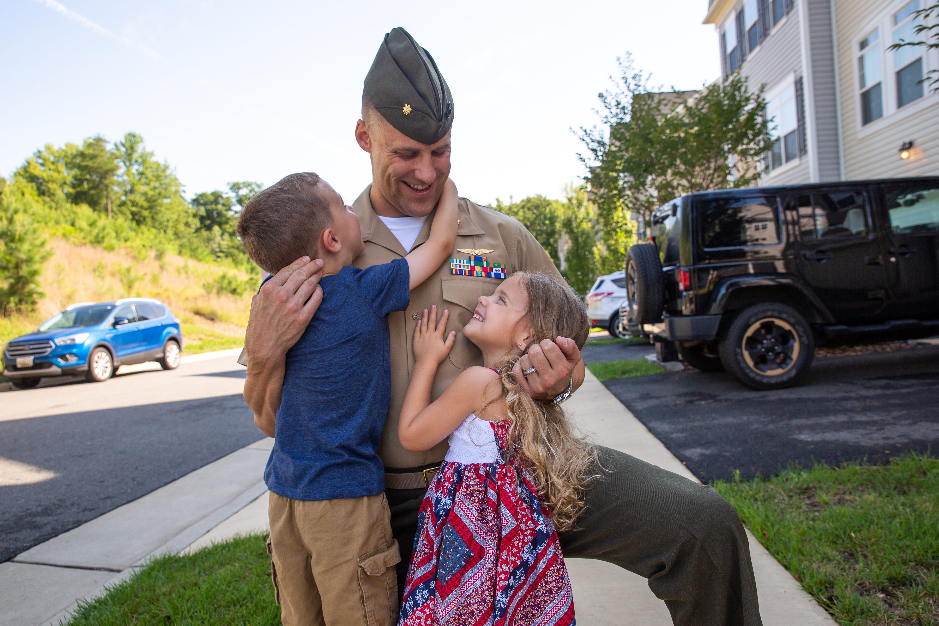 Servicemember hugging his two children